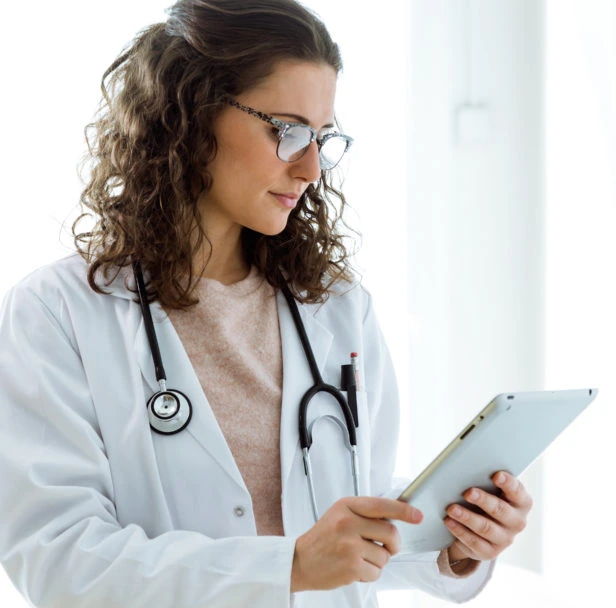 Female doctor using her digital tablet in the consultation